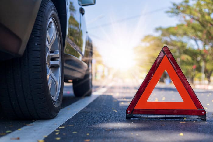 Orange triangle next to car -Emergency Preparedness: 10 Things to Keep in Your Car