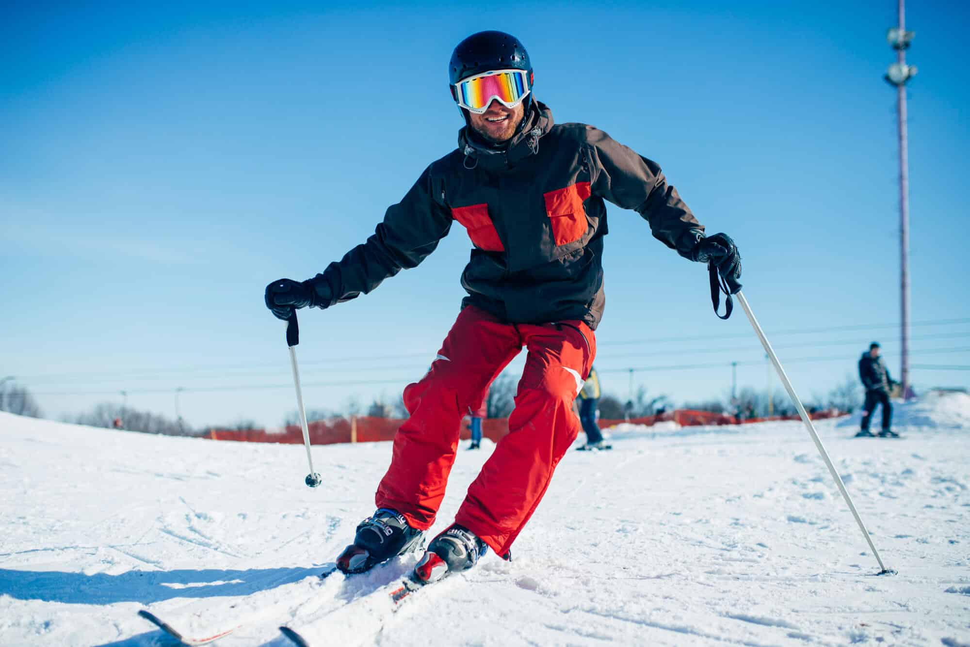 Skier with safety glasses on, smiling -Winter Sport Safety