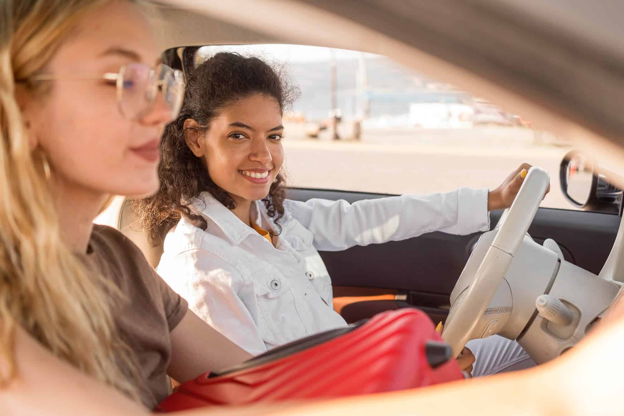 Women driving car in summer