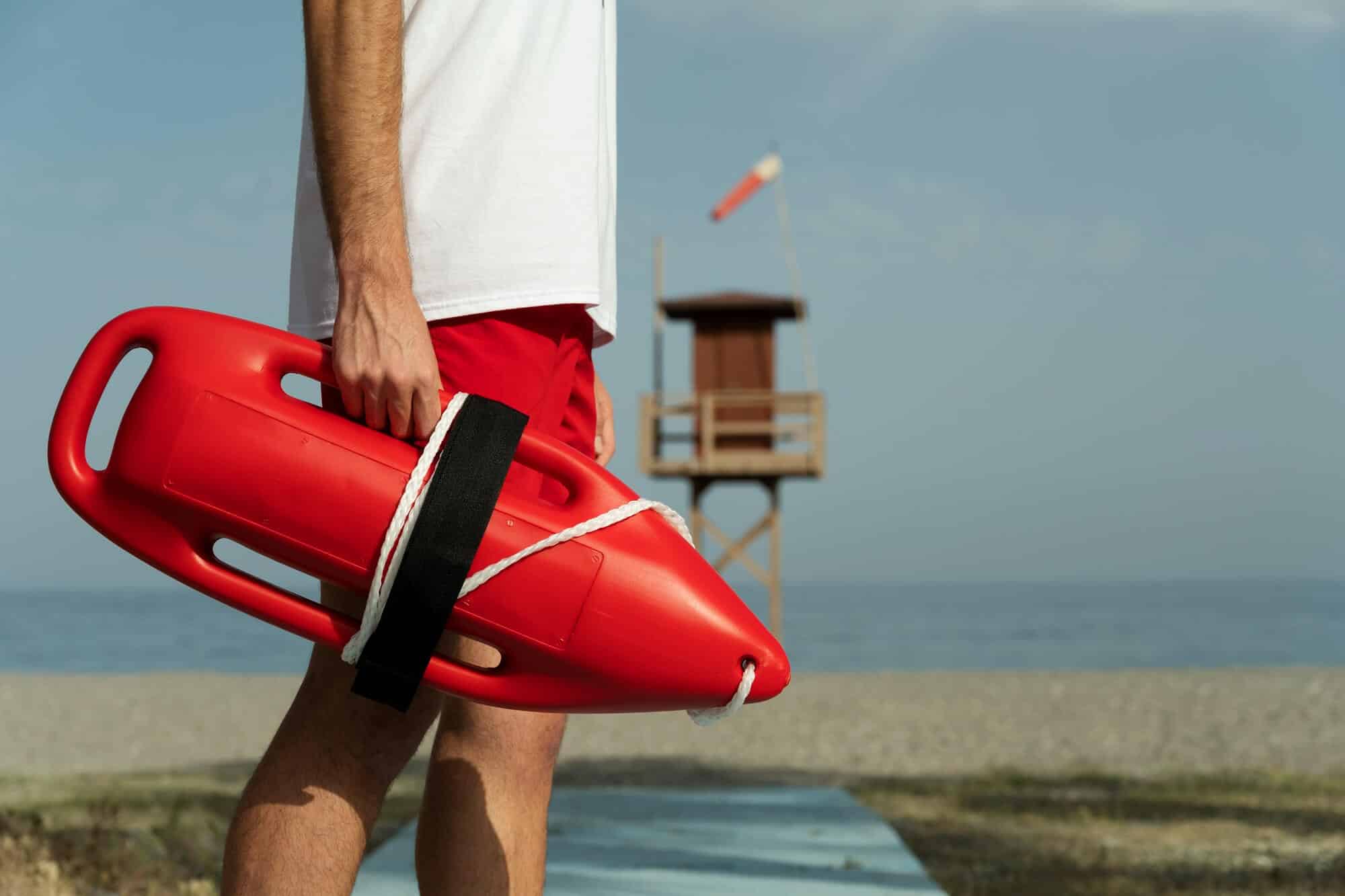 Side view lifeguard holding lifesaving buoy - Liable for Drownings