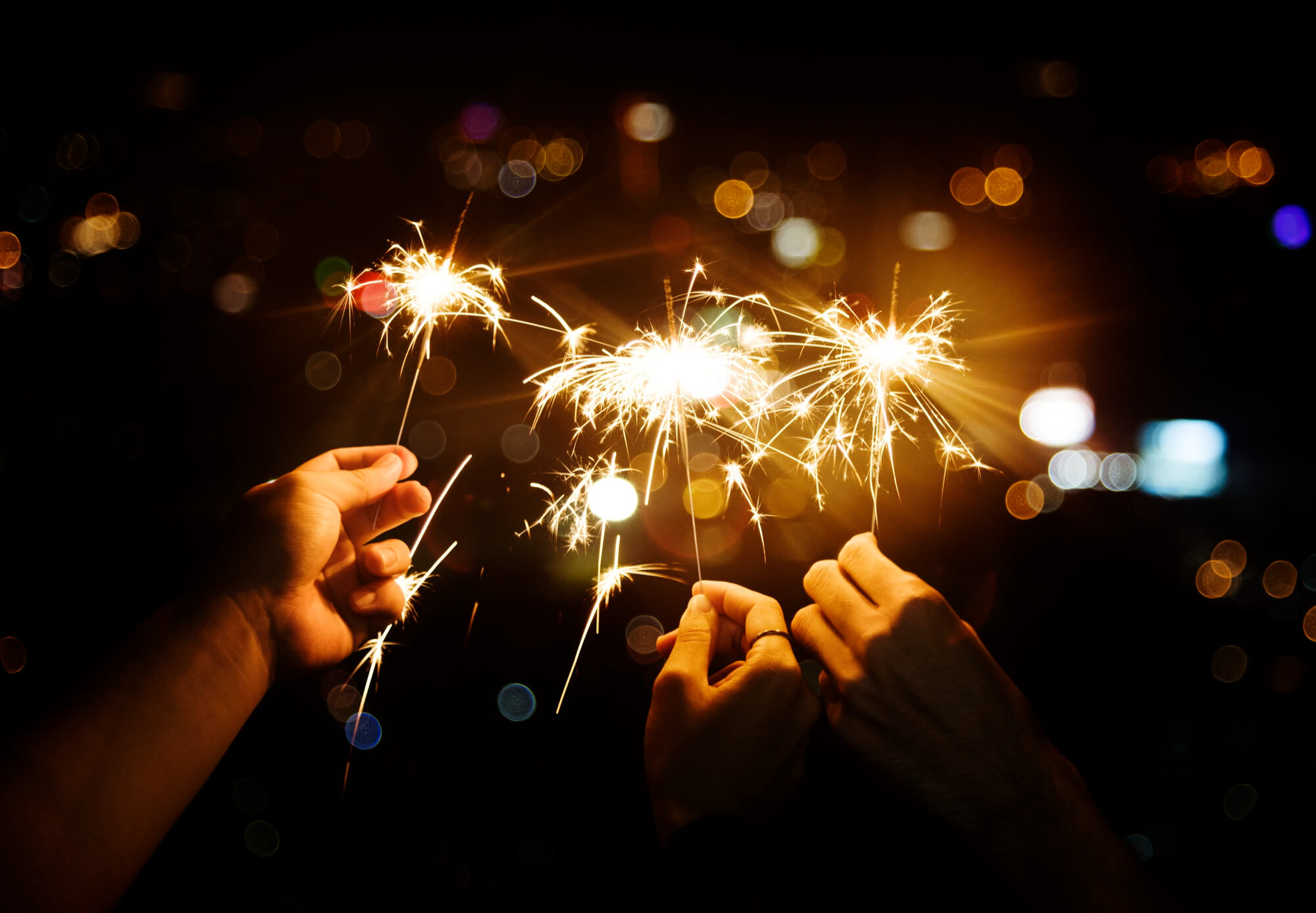 Celebrating New Year's Eve with sparklers in the night