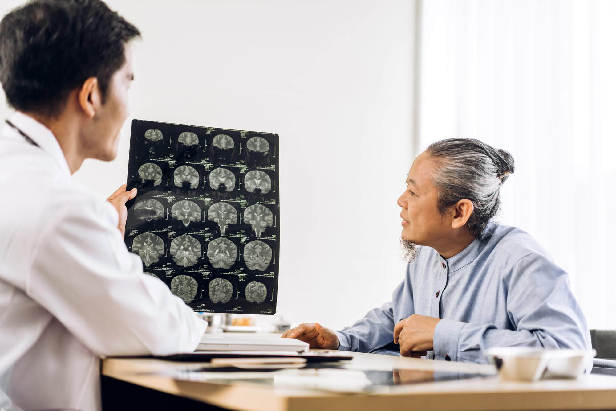 Doctor showing patient brain scans